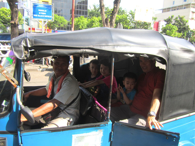 Watching nieces/nephews enjoying a ride in a bajaj