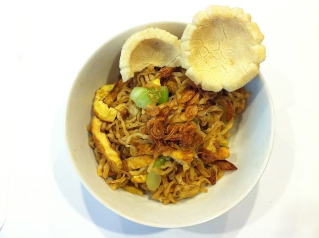 Pan fry noodles with fish chips on the side. Very typical Indonesian way to eat noodles!